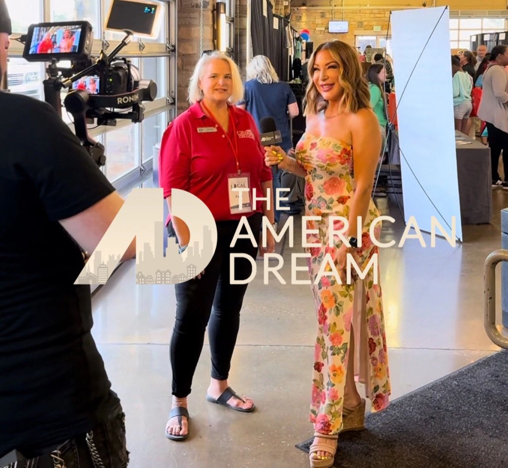 Barbie interviewing a guest on camera for The American Dream